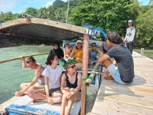 A group of young people going for a boat ride Alam Kita, located at the island Karimunjawa in Indonesia